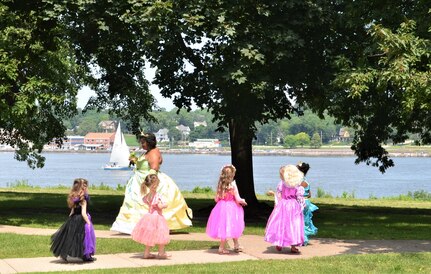 Princess Tiana leads the princess parade along the Mississippi River during the “Storytime with Princesses” event held at Rock Island Arsenal, Illinois, July 17.