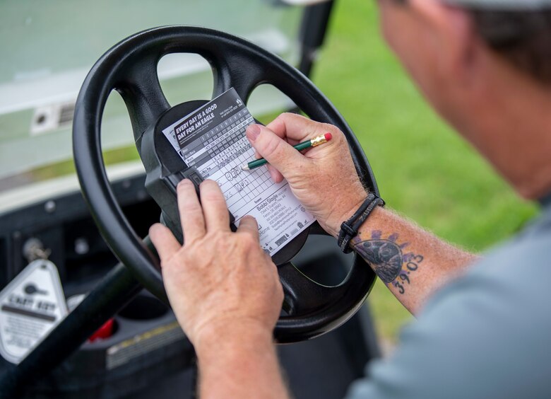 Steven Weber, 436th Force Support Squadron Eagle Lanes manager, fills out his scorecard during an intramural golf match at the Eagle Creek Golf Course on Dover Air Force Base, Delaware, August 3, 2021. Eight intramural golf teams are finishing up the regular season and preparing for playoffs in September. (U.S. Air Force photo by Tech. Sgt. Nicole Leidholm)