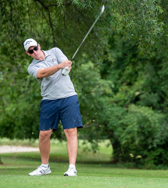 Senior Airman Kevin Nolan, 436th Maintenance Squadron Isochronal Maintenance Dock engine technician, drives a golf ball during an intramural golf match at the Eagle Creek Golf Course on Dover Air Force Base, Delaware, August 3, 2021. Eight intramural golf teams are finishing up the regular season and preparing for playoffs in September. (U.S. Air Force photo by Tech. Sgt. Nicole Leidholm)