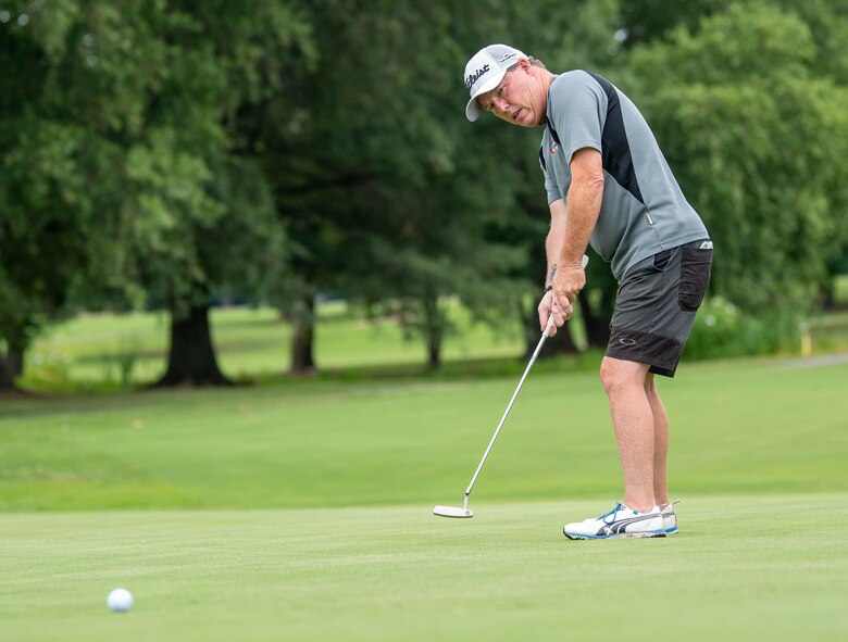 Steven Weber, 436th Force Support Squadron Eagle Lanes manager, putts on the green during an intramural golf match at the Eagle Creek Golf Course on Dover Air Force Base, Delaware, August 3, 2021. Eight intramural golf teams are finishing up the regular season and preparing for playoffs in September. (U.S. Air Force photo by Tech. Sgt. Nicole Leidholm)