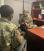 Chaplain (LTC) Angela White advises a member of the Kentucky National Guard on some of the employment services offered at the G1