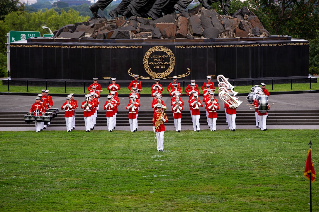 Marines with “The Commandant’s Own,” U.S. Marine Drum and Bugle Corps, perform during the Tuesday Sunset Parade at the Marine Corps War Memorial, Arlington, Va., Aug. 3, 2021. The guest of honor for the evening was Mr. Erik Raven, majority staff director of the Senate Appropriations Committee-Defense, and the hosting official was Brig. Gen. Eric Austin, director, Capabilities Development Directorate. (U.S. Marine Corps photo by Lance Cpl. Mark A. Morales)
