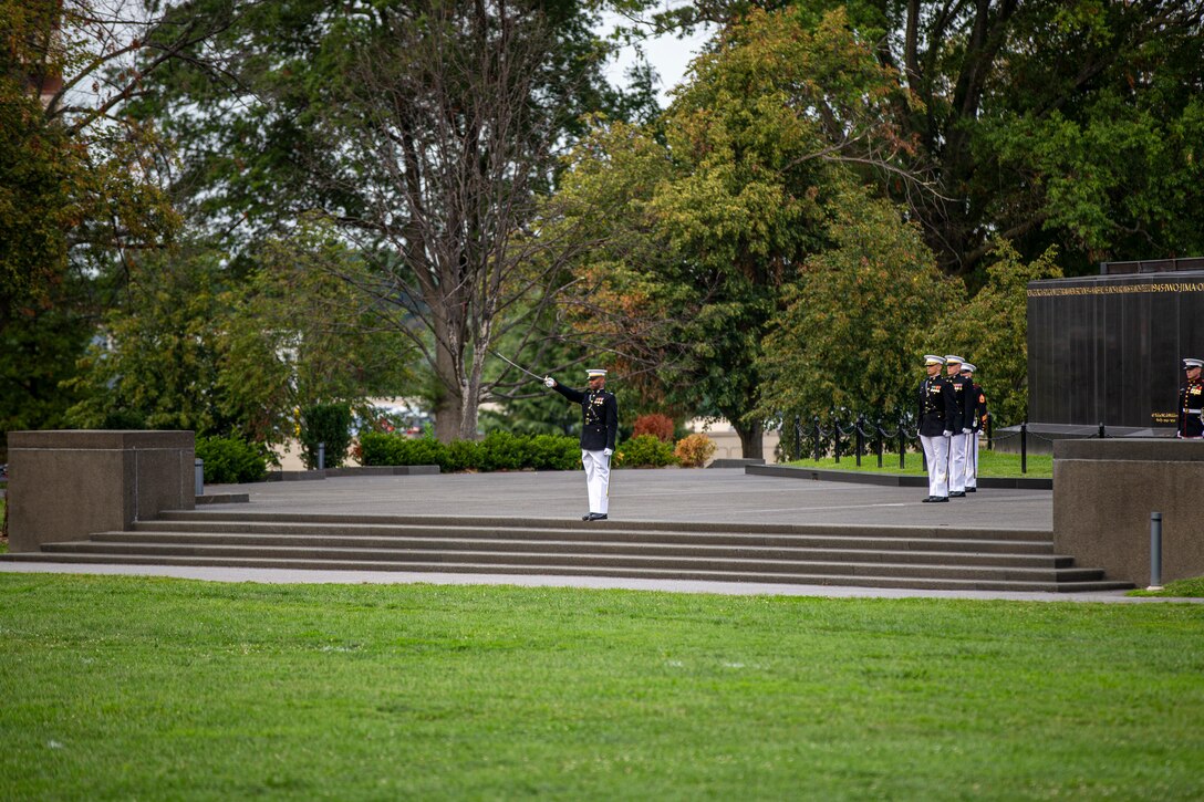 Captain Bryan Hart, parade adjutant, executes “draw sword” during the Tuesday Sunset Parade at the Marine Corps War Memorial, Arlington, Va., Aug. 3, 2021. The guest of honor for the evening was Mr. Erik Raven, majority staff director of the Senate Appropriations Committee-Defense, and the hosting official was Brig. Gen. Eric Austin, director, Capabilities Development Directorate. (U.S. Marine Corps photo by Lance Cpl. Mark A. Morales)