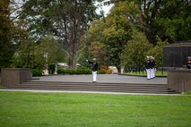 Captain Bryan Hart, parade adjutant, executes “draw sword” during the Tuesday Sunset Parade at the Marine Corps War Memorial, Arlington, Va., Aug. 3, 2021.