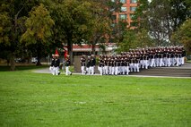 Marines with Marine Barracks Washington march into formation during the Tuesday Sunset Parade at the Marine Corps War Memorial, Arlington, Va., Aug. 3, 2021.
