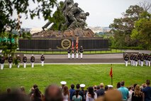 Marines with the Official U.S. Marine Corps Color Guard present the National Ensign during the Tuesday Sunset Parade at the Marine Corps War Memorial, Arlington, Va., Aug. 3, 2021.