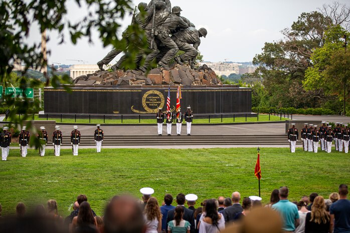 Marines with the Official U.S. Marine Corps Color Guard present the National Ensign during the Tuesday Sunset Parade at the Marine Corps War Memorial, Arlington, Va., Aug. 3, 2021.