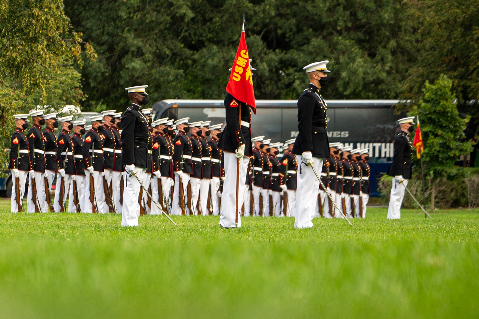 Marines with Marine Barracks Washington stand at the position of attention during the Tuesday Sunset Parade at the Marine Corps War Memorial, Arlington, Va., Aug. 3, 2021.