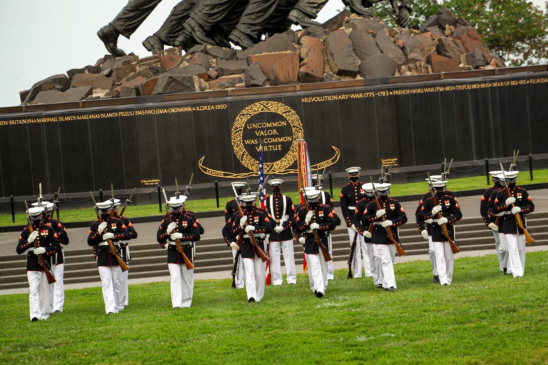 Marines with the Silent Drill Platoon perform during the Tuesday Sunset Parade at the Marine Corps War Memorial, Arlington, Va., Aug. 3, 2021.
