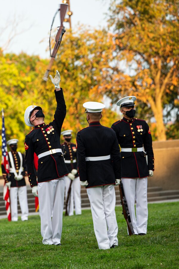 Marines with the Silent Drill Platoon conduct their “rifle inspection” during the Tuesday Sunset Parade at the Marine Corps War Memorial, Arlington, Va., Aug. 3, 2021. The guest of honor for the evening was Mr. Erik Raven, majority staff director of the Senate Appropriations Committee-Defense, and the hosting official was Brig. Gen. Eric Austin, director, Capabilities Development Directorate. (U.S. Marine Corps photo by Lance Cpl. Allen T. Sanders)