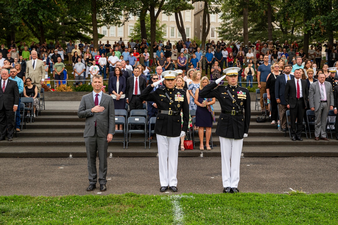 From left-to-right, Mr. Erik Raven, majority staff director of the Senate Appropriations Committee-Defense, Brig. Gen. Eric Austin, director, Capabilities Development Directorate, and Col. Teague A. Pastel, commanding officer, Marine Barracks Washington, stand at the position of attention and render a salute during “honors” for the Tuesday Sunset Parade a at the Marine Corps War Memorial, Aug. 3, 2021.