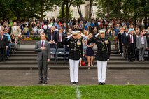 From left-to-right, Mr. Erik Raven, majority staff director of the Senate Appropriations Committee-Defense, Brig. Gen. Eric Austin, director, Capabilities Development Directorate, and Col. Teague A. Pastel, commanding officer, Marine Barracks Washington, stand at the position of attention and render a salute during “honors” for the Tuesday Sunset Parade a at the Marine Corps War Memorial, Aug. 3, 2021.