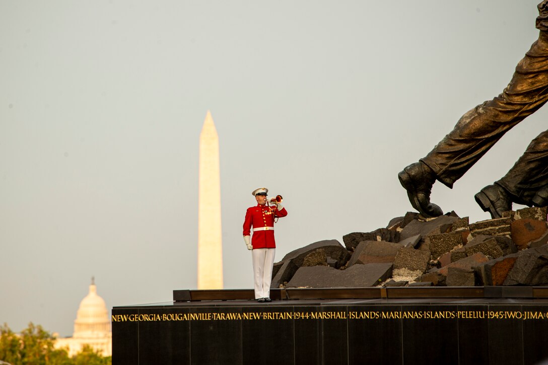 Staff Sgt. Christopher Walker, ceremonial bugler with “The Commandant’s Own,” U.S. Marine Drum and Bugle Corps, plays “Taps” during the Tuesday Sunset Parade at the Marine Corps War Memorial, Arlington, Va., Aug. 3, 2021. The guest of honor for the evening was Mr. Erik Raven, majority staff director of the Senate Appropriations Committee-Defense, and the hosting official was Brig. Gen. Eric Austin, director, Capabilities Development Directorate. (U.S. Marine Corps photo by Lance Cpl. Allen T. Sanders)