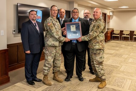 Photo of employees accepting the award