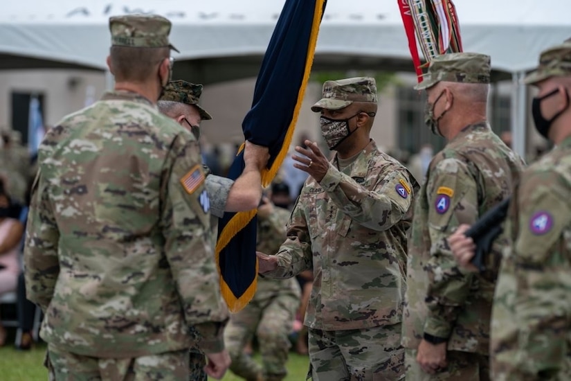 Marine Corps Gen. Kenneth McKenzie, Commander of U.S. Central Command, passes the U.S. Army Central colors to incoming Commanding General, Lt. Gen. Ronald P. Clark, during the Army Service Component Command's Change of Command ceremony at Patton Hall's Lucky Park on Shaw Air Force Base, S.C., Aug. 4, 2021. During the ceremony, Clark assumed command from outgoing Commanding General, Lt. Gen. Terry Ferrell. (U.S. Army photo by Sgt. Leo Jenkins)