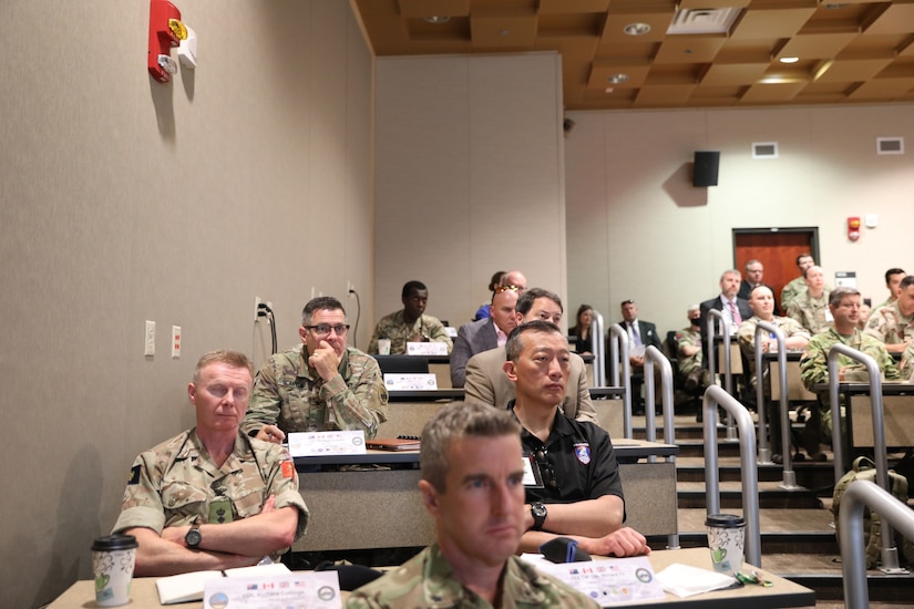 U.S. Army Reserve Col. Straus M. Scantlin (upper left), director of the Strategic Initiatives Group (SIG) for the U.S. Army Civil Affairs and Psychological Operations Command (Airborne), takes part in the Joint Warfighting Assessment 2021 distinguished visitor day initial briefing by Col. Tobin Magsig, commander of the Joint Modernization Command, at Fort Carson, Colo., June 25, 2021. USACAPOC(A) Civil Affairs, Psychological Operations and Information Operations Soldiers took part in JWA 2021 with participants from different Army units and multinational partners such as U.K., Australian and Canadian armed forces, working to improve interoperability between U.S. joint forces and our allies. JWA exercises help the Army evaluate emerging concepts, integrate new technologies, and promote interoperability between the Army, other services, and our multinational partners. Joint and multinational partners are key to the success of Multi-Domain Operations.