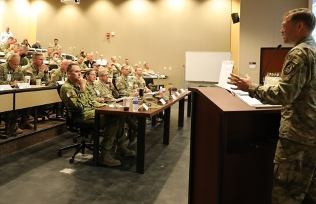 Lt. Gen. Jody J. Daniels, chief of Army Reserve and commanding general, U.S. Army Reserve Command (front table, second from left), participates in the Joint Warfighting Assessment 2021 distinguished visitor day initial briefing at Fort Carson, Colo., June 25, 2021. U.S. Army Civil Affairs and Psychological Operations Command (Airborne) Civil Affairs, Psychological Operations, and Information Operations Soldiers took part in JWA 2021 with participants from different Army units and multinational partners such as U.K., Australian and Canadian armed forces, working to improve interoperability between U.S. joint forces and our allies. JWA exercises help the Army evaluate emerging concepts, integrate new technologies, and promote interoperability between the Army, other services, and our multinational partners. Joint and multinational partners are key to the success of Multi-Domain Operations.