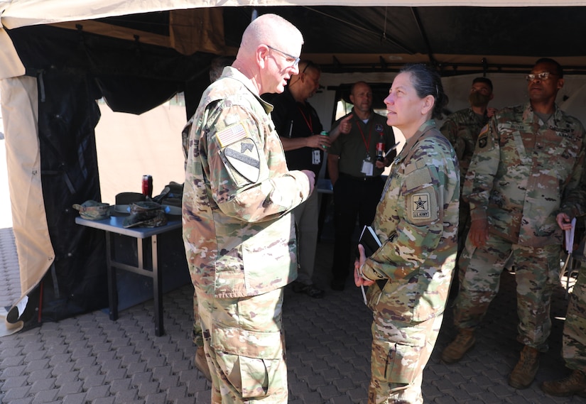 Brig. Gen. Gen. Jeffrey C. Coggin (left), commanding general of the U.S. Army Civil Affairs and Psychological Operations Command (Airborne), speaks with Lt. Gen. Jody J. Daniels (right), chief of Army Reserve and commanding general, U.S. Army Reserve Command, as they participate in the Joint Warfighting Assessment 2021 distinguished visitor day initial briefing at Fort Carson, Colo., June 25, 2021. U.S. Army Civil Affairs and Psychological Operations Command (Airborne) Civil Affairs, Psychological Operations, and Information Operations Soldiers took part in JWA 2021 with participants from different Army units and multinational partners such as U.K., Australian and Canadian armed forces, working to improve interoperability between U.S. joint forces and our allies. JWA exercises help the Army evaluate emerging concepts, integrate new technologies, and promote interoperability between the Army, other services, and our multinational partners. Joint and multinational partners are key to the success of Multi-Domain Operations.