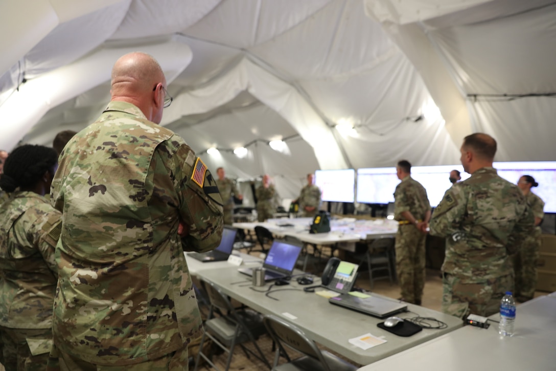U.S. Army Reserve Brig. Gen. Jeffrey C. Coggin (left), commanding general of the U.S. Army Civil Affairs and Psychological Operations Command (Airborne), participates in the Joint Warfighting Assessment 2021 distinguished visitor at Fort Carson, Colo., June 25, 2021. USACAPOC(A) Civil Affairs, Psychological Operations, and Information Operations Soldiers took part in JWA 2021 with participants from different Army units and multinational partners such as U.K., Australian and Canadian armed forces, working to improve interoperability between U.S. joint forces and our allies. JWA exercises help the Army evaluate emerging concepts, integrate new technologies, and promote interoperability between the Army, other services, and our multinational partners. Joint and multinational partners are key to the success of Multi-Domain Operations.