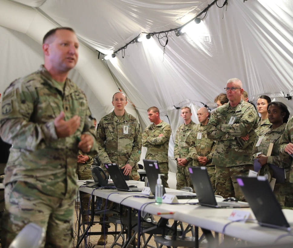 U.S. Army Reserve Brig. Gen. Jeffrey C. Coggin (center right), commanding general of the U.S. Army Civil Affairs and Psychological Operations Command (Airborne), participates in the Joint Warfighting Assessment 2021 distinguished visitor at Fort Carson, Colo., June 25, 2021. USACAPOC(A) Civil Affairs, Psychological Operations, and Information Operations Soldiers took part in JWA 2021 with participants from different Army units and multinational partners such as U.K., Australian and Canadian armed forces, working to improve interoperability between U.S. joint forces and our allies. JWA exercises help the Army evaluate emerging concepts, integrate new technologies, and promote interoperability between the Army, other services, and our multinational partners. Joint and multinational partners are key to the success of Multi-Domain Operations.