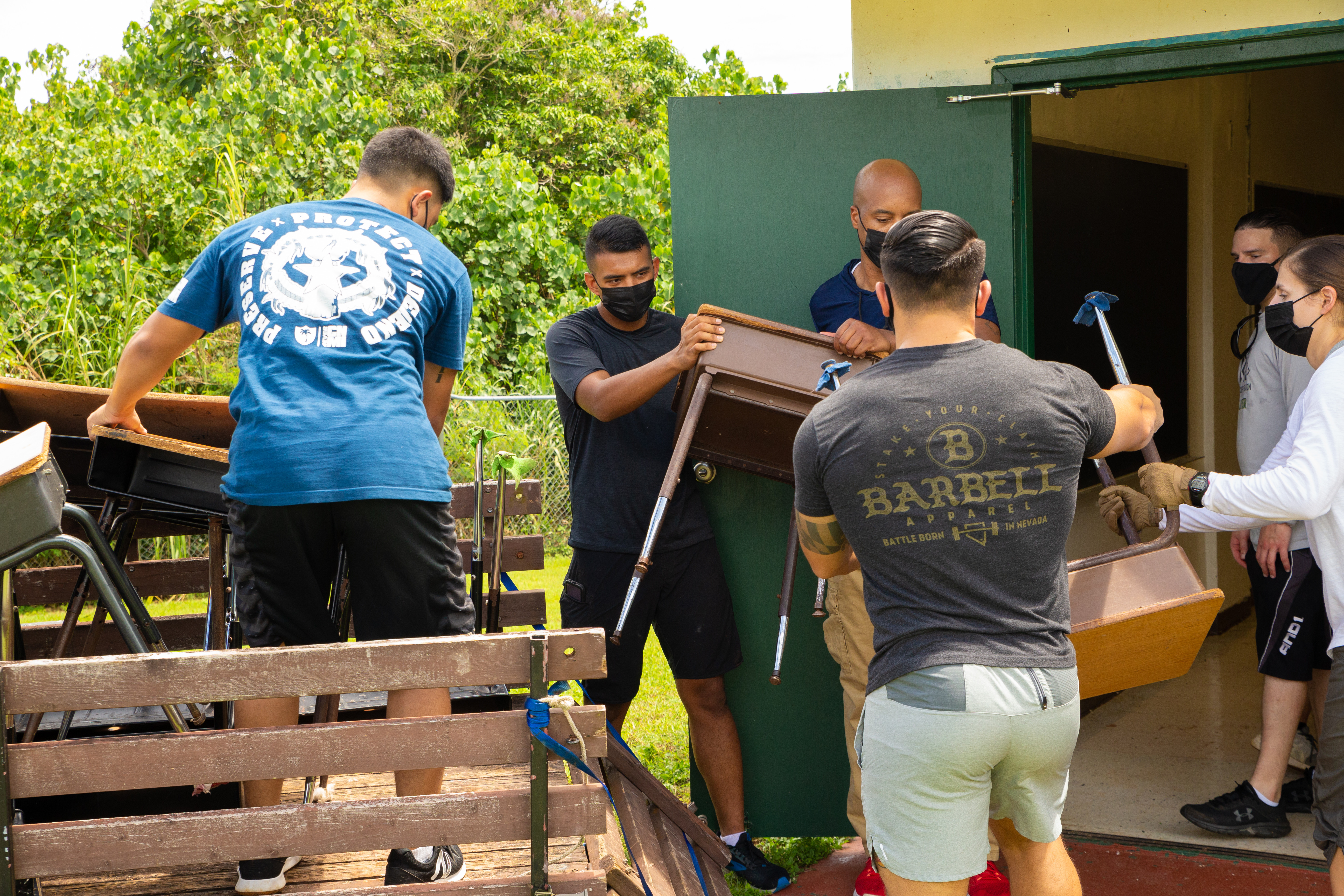 U.S. Marines assigned to Marine Corps Base (MCB) Camp Blaz move damaged furniture into storage during a volunteer event at Finegayan Elementary School, July 30, 2021.