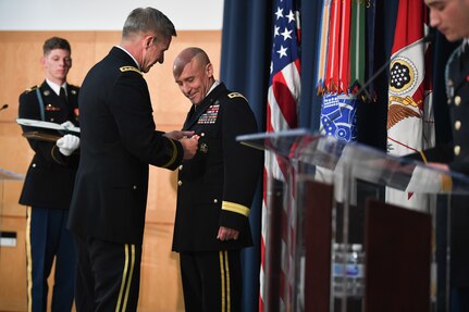 U.S. Army Gen. James C. McConville presents the Distinguished Service Medal to U.S. Army Lt. Gen. Thomas A. Horlander during a retirement ceremony at Lincoln Hall, Ft. McNair in Washington, D.C., June 23, 2021.  (U.S. Army photo by Joseph B. Lawson)