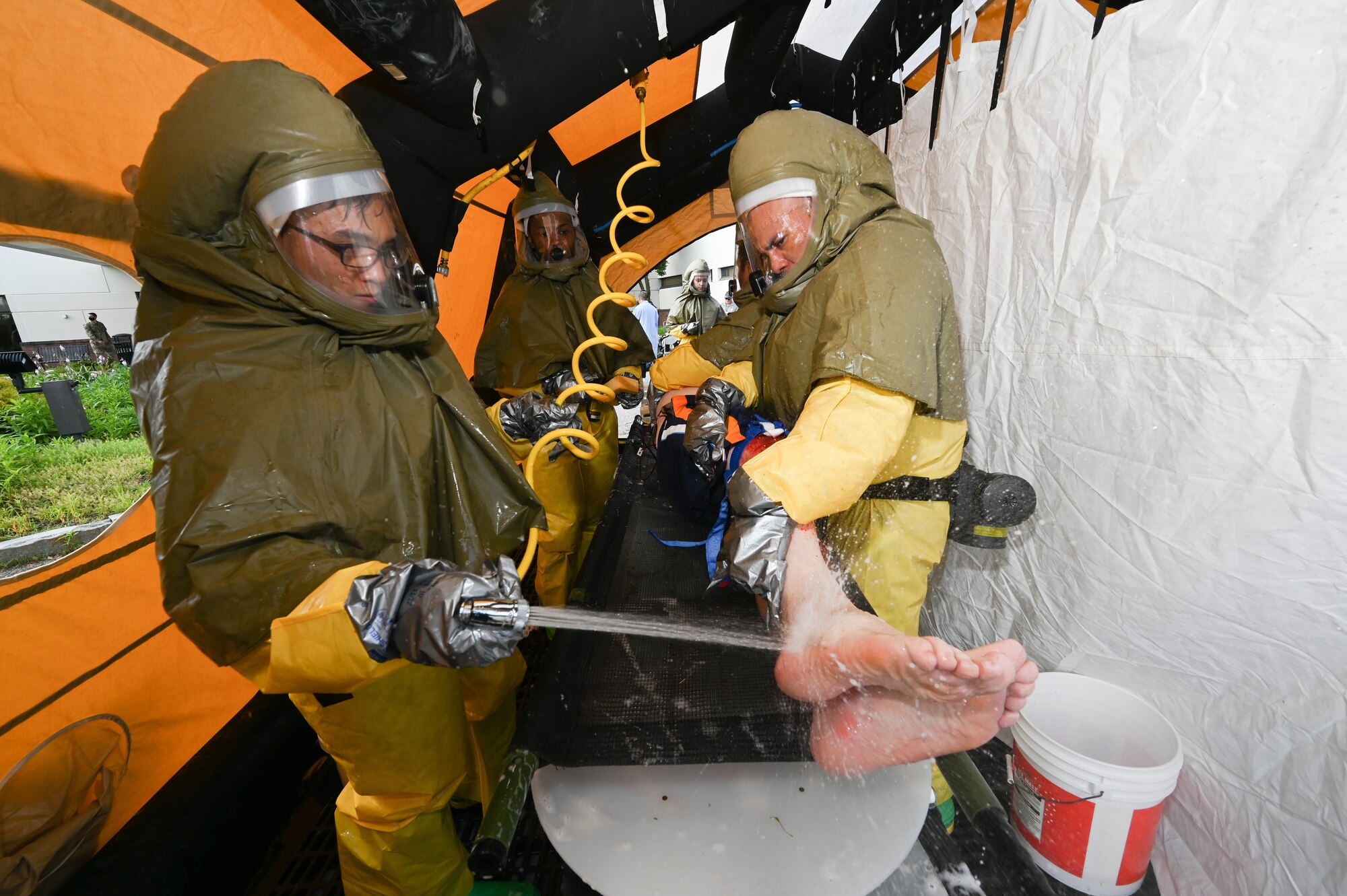 66th Medical Squadron In-Place Patient Decontamination Team members Airman 1st Class Ray Infante, left, and Master Sgt. Julio Arriola, participate in a Ready Eagle exercise at Hanscom Air Force Base, Mass., July 30. The full-scale disaster response exercise tested Hanscom medics on their response to a chemical, biological, radiological, nuclear or explosive event. (U.S. Air Force photo by Todd Maki)