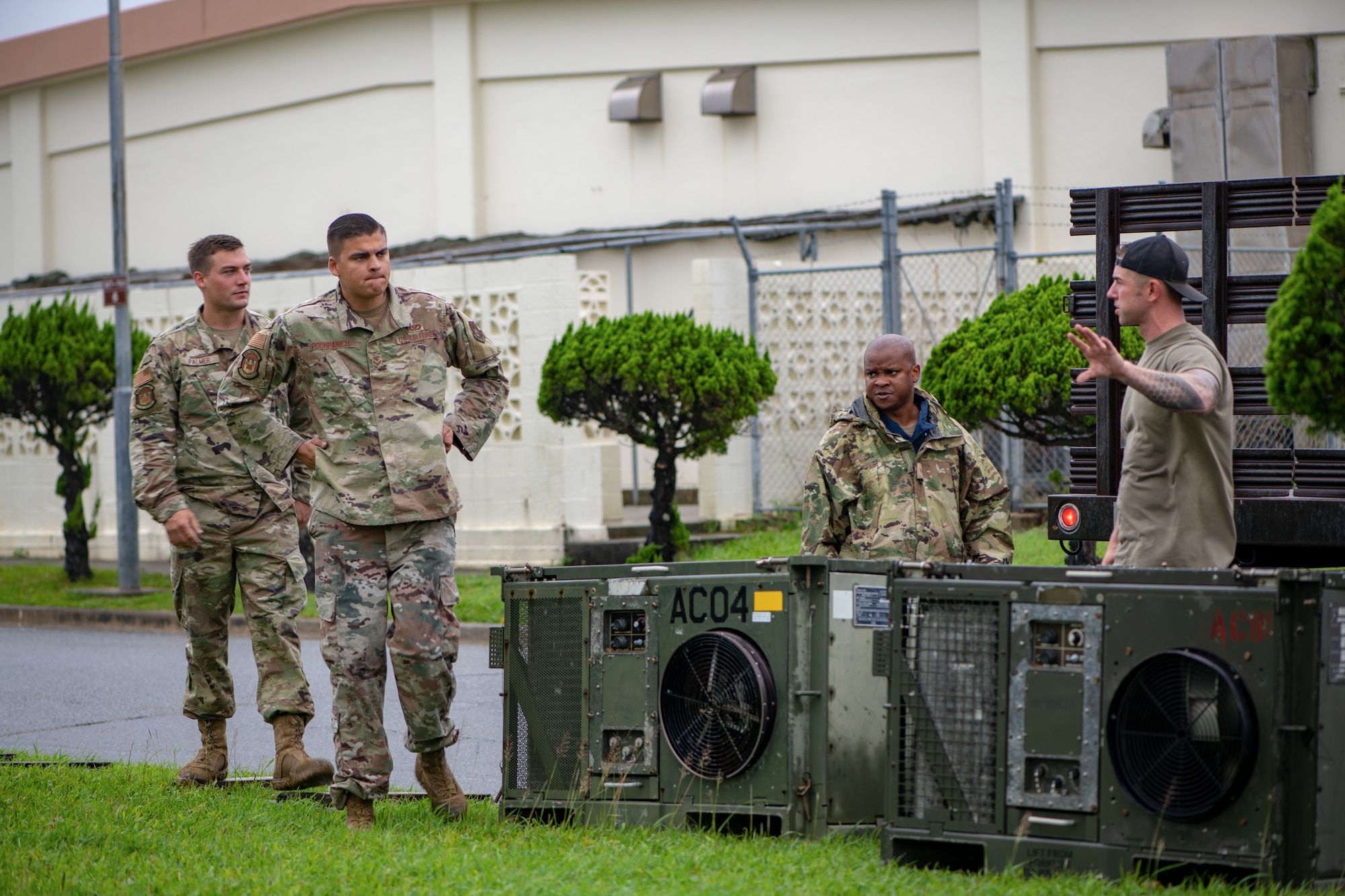 Airmen relocate heating, ventilation and air conditioning systems while setting up tents for Pacific Iron.