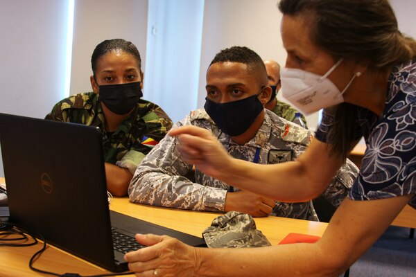 (July 27, 2021) Lynne Tablewski, right, conducts SeaVision familiarization training with Seychelles Coast Guard Private Shamira Simeon, left, and Seychelles Air Force Private Christopher Noiin during exercise Cutlass Express 2021 at the Regional Coordination Operation Center in Victoria, Seychelles, July 27, 2021. Cutlass Express is designed to improve regional cooperation, maritime domain awareness and information sharing practices to increase capabilities between the U.S., East African and Western Indian Ocean nations to counter illicit maritime activity.