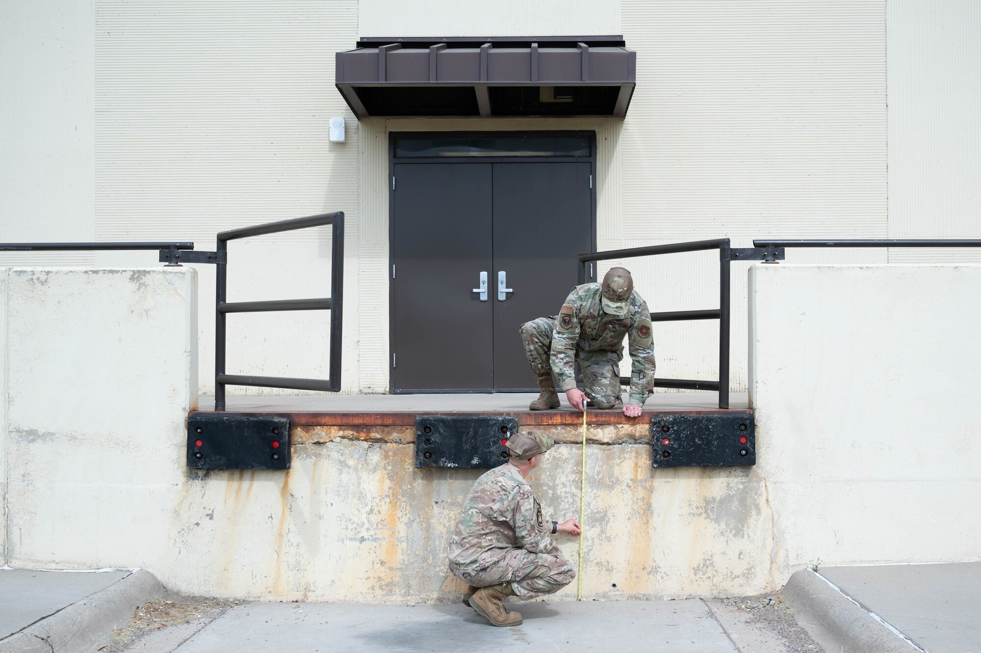 Staff Sgt. Justin Manning, right, 341st Missile Wing occupational safety technician, and Tech. Sgt. Mark Allen, left, 341st MW occupational safety NCO in charge, measure the height of a loading dock Aug. 2, 2021, at Malmstrom Air Force Base, Mont.