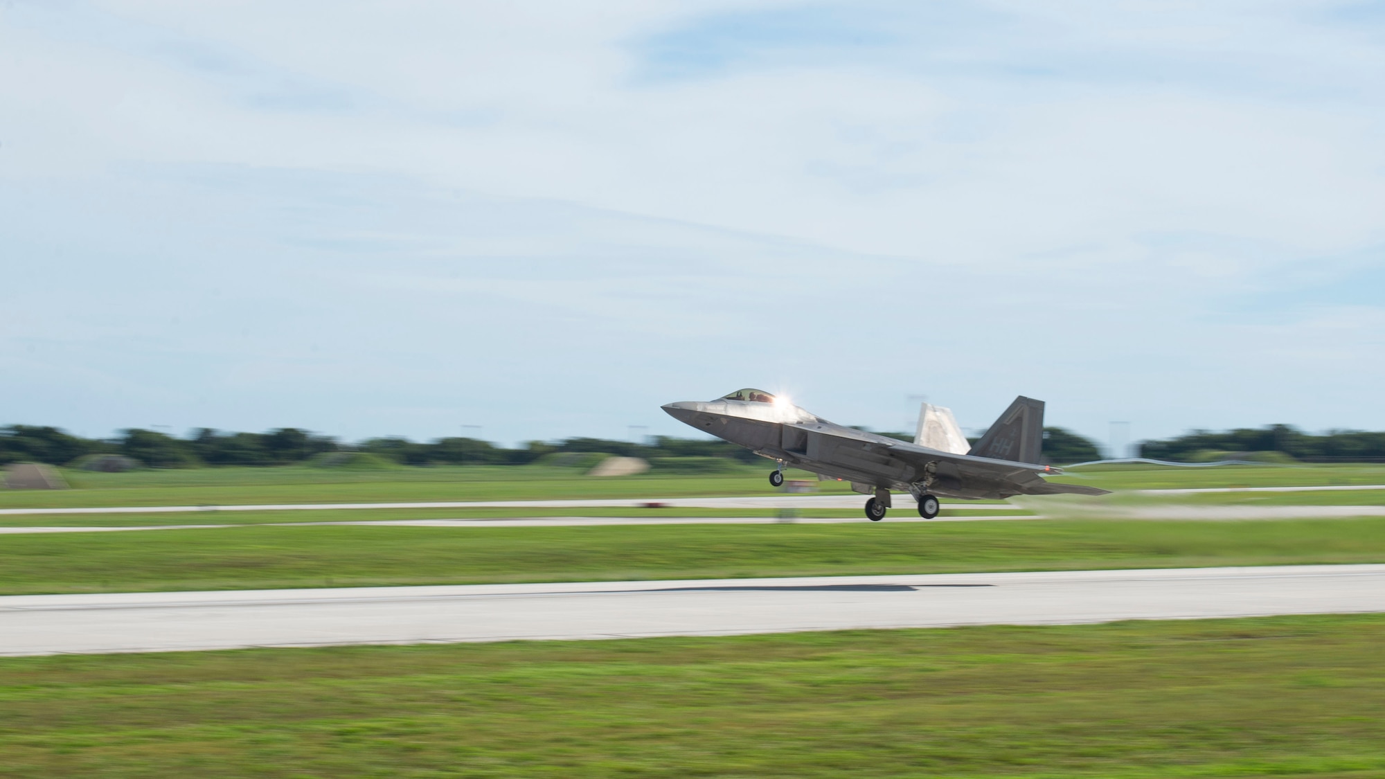 A U.S. Air Force F-22 Raptor assigned to Joint Base Pearl Harbor-Hickam, Hawaii takes off during a flight line engagement for Pacific Iron 2021 at Andersen Air Force Base, Guam, Aug. 4, 2021. PACIRON provides effective, flexible, and capabilities-centered forces, ready for deployment worldwide, and enables real-world proficiency in response to a crisis. (U.S. Air Force photo by Senior Airman Aubree Owens)