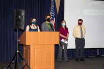 Norfolk Naval Shipyard (NNSY) employees Victoria Pendleton, Derek Metzger, Wendy Cline and Matthew Hahn present their capstone projects at the Code 130 Quality Employee Development Program graduation ceremony.
