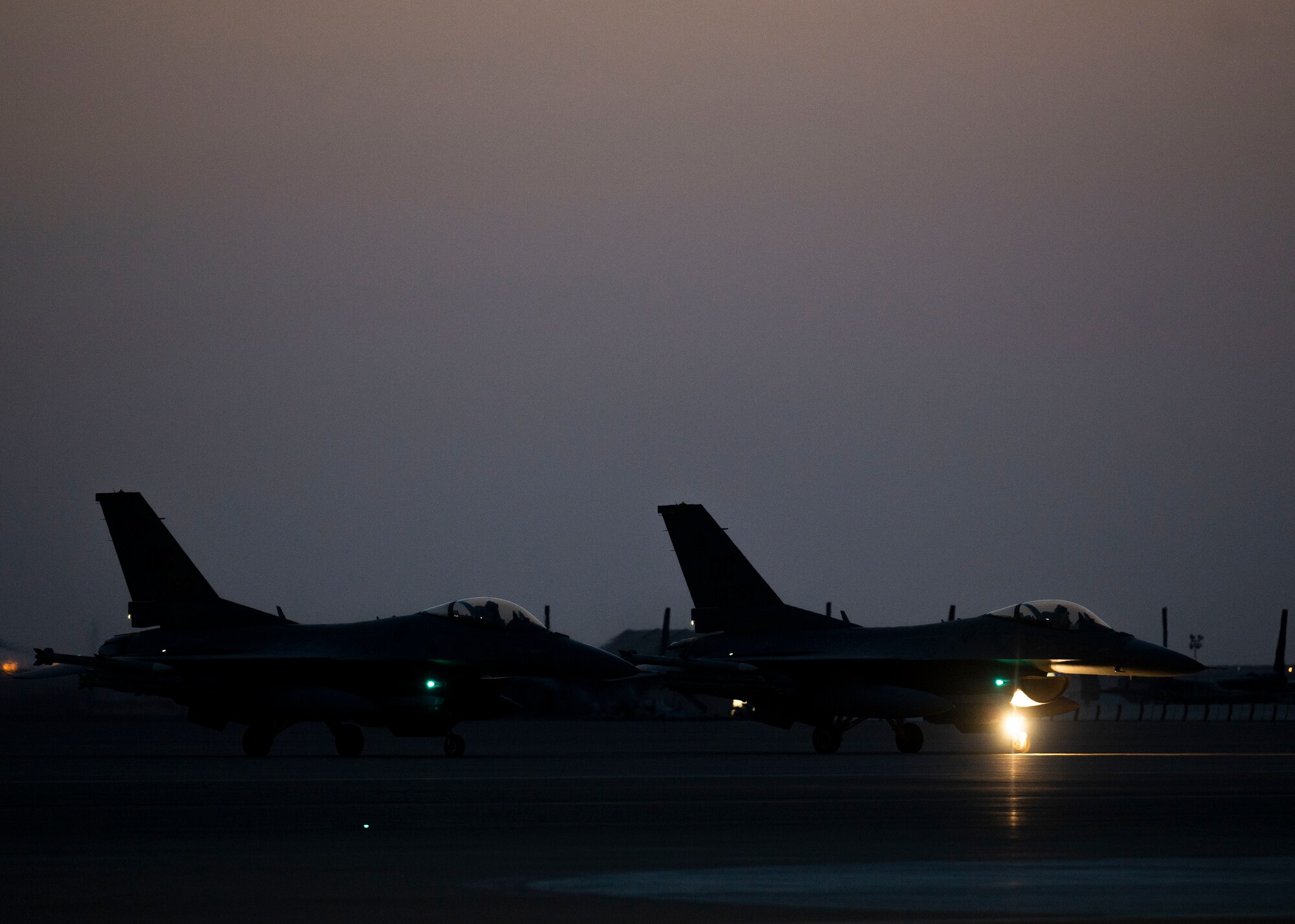 Two U.S. Air Force F-16 Fighting Falcons taxi on the runway at Prince Sultan Air Base, Kingdom of Saudi Arabia, after participating in a combined counter-unmanned aerial systems training operation with Royal Saudi aircraft, July 29, 2021. Protecting U.S. and allied forces against UAS continues to be a top priority in the U.S. Central Command theater of operations. (U.S. Air Force photo by Senior Airman Samuel Earick)