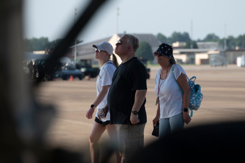 Two women and a man walk on the flight line.