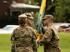 U.S. Army Reserve Col. Franklin J. Estes, incoming commander for the 151st Theater Information Operations Group, returns the unit colors to acting TIOG command sergeant major, U.S. Army Reserve Command Sgt. Maj. Troy A. Hershberger, during the change of command at Fort Totten, New York, July 18, 2021.