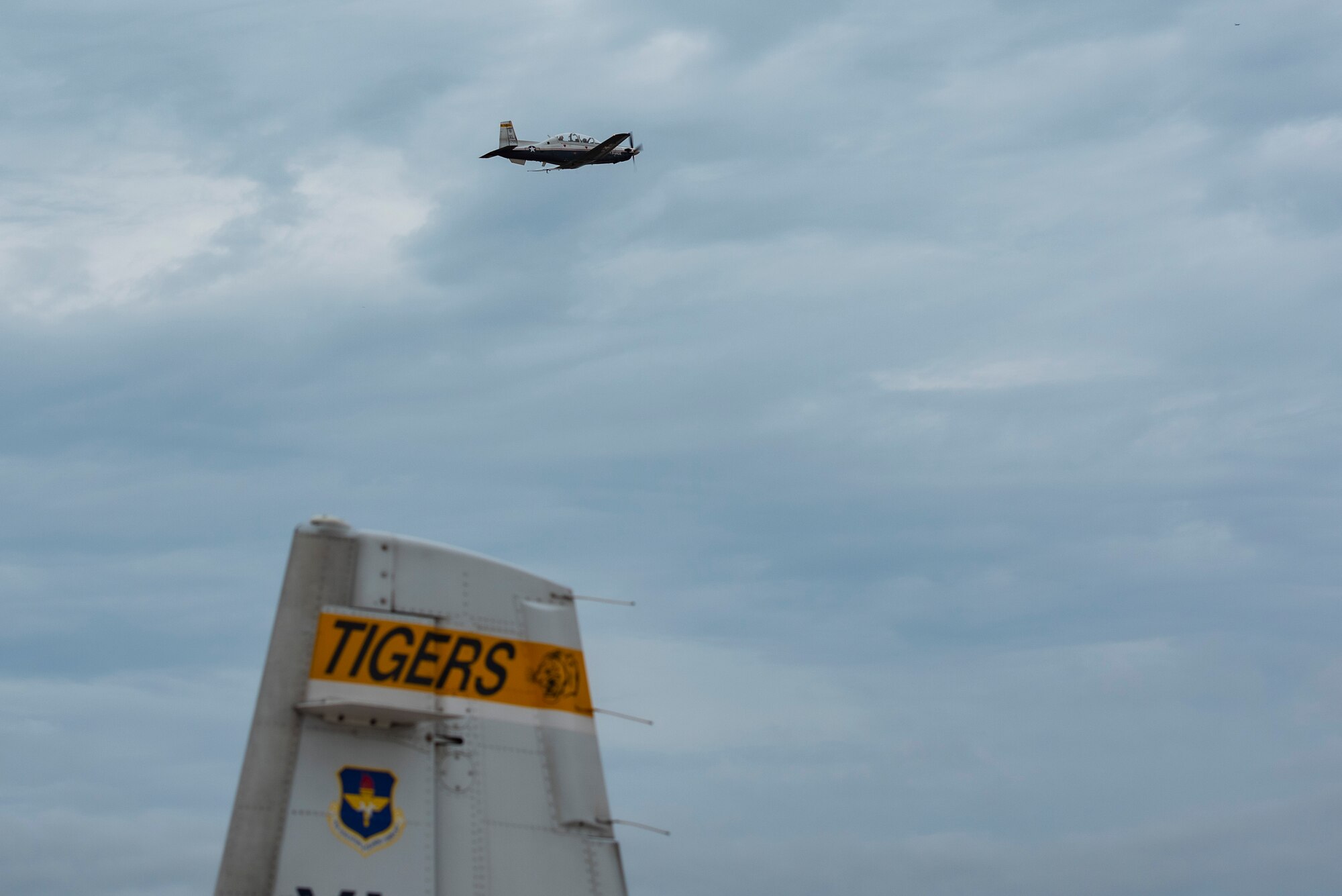 A T-6 Texan II glides through the air over Laughlin Air Force Base on 8/5 day on Aug. 5, 2021.Pilots on Tiger Day took to the sky to celebrate their heritage for being a part of the 85th Flying Training Squadron in a competition against fellow instructor pilots. (U.S. Air Force Photo by Airman 1st Class David Phaff)