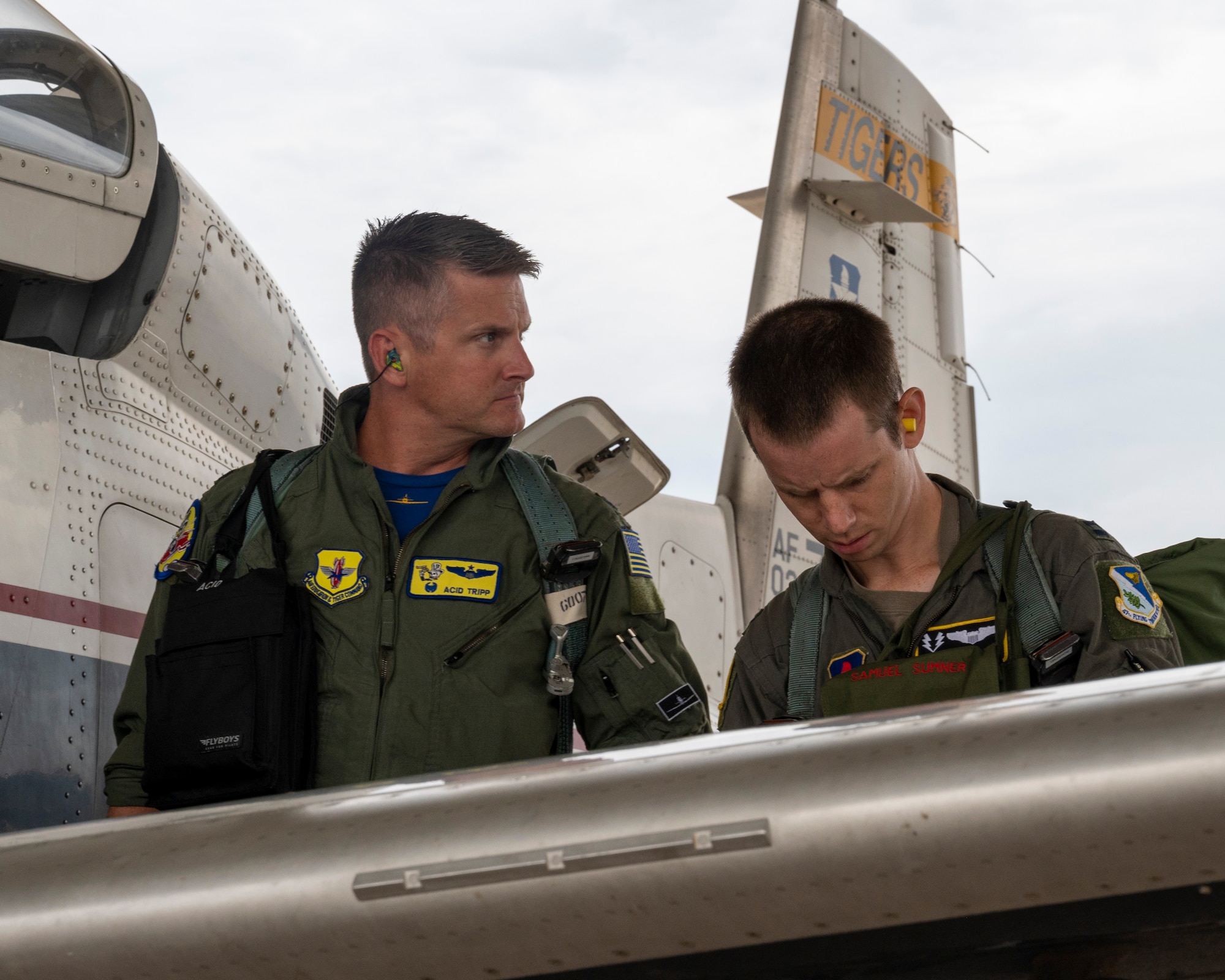 U.S. Air Force Lt. Col. Brian “Tiger King” Tripp, 85th Flying Training Squadron commander, goes over a pre flight checklist with Capt. Samuel Sumner, 85th Flying Training Squadron instructor pilot, before flying on Tiger Day at Laughlin Air Force Base, Texas on August 5, 2021. Pilots on Tiger Day took to the sky to celebrate their heritage for being a part of the 85th Flying Training Squadron in a competition against fellow instructor pilots. (U.S. Air Force Photo by Senior Airman Nicholas Larsen)