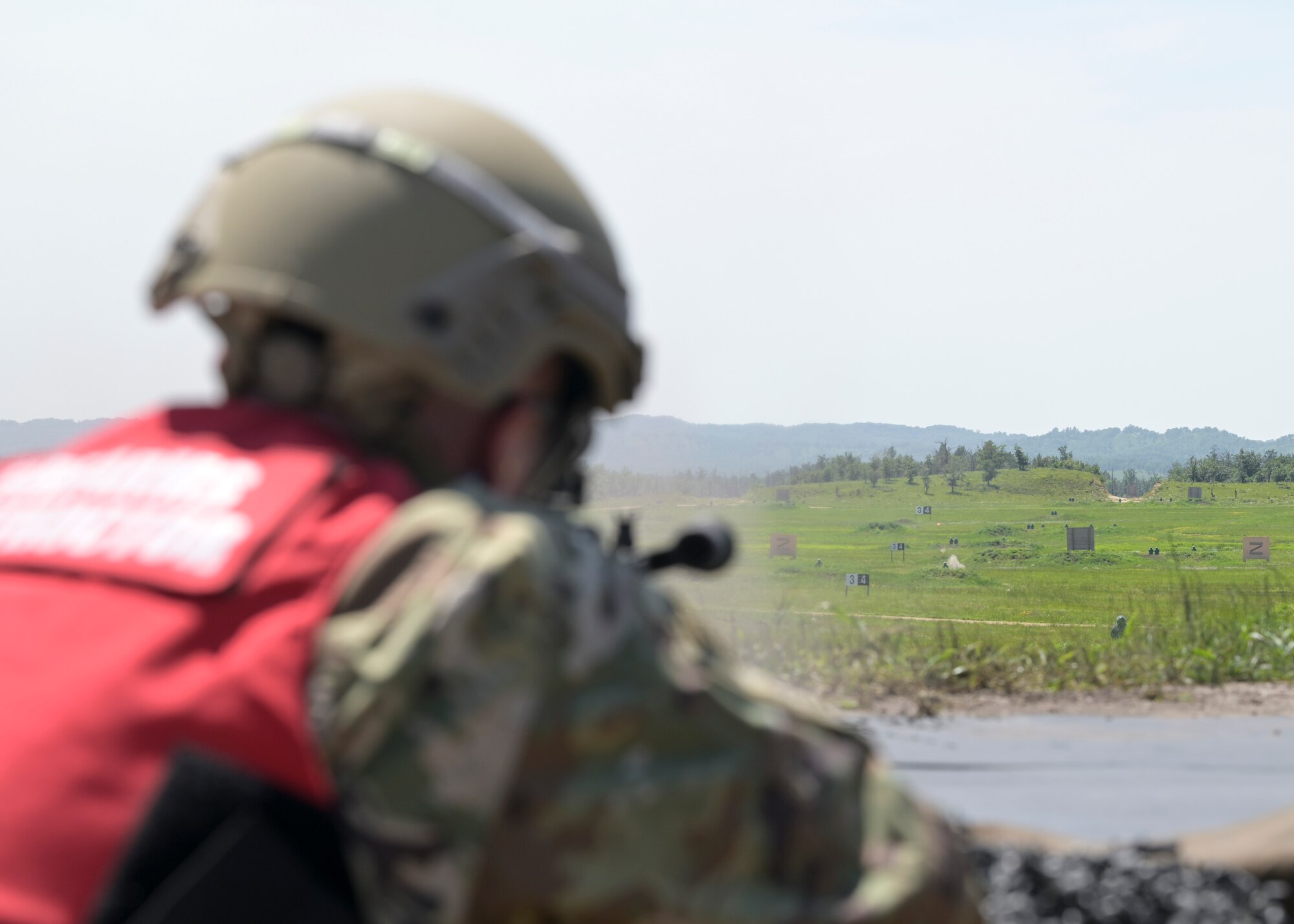 A combat arms training and maintenance Airmen assigned to the 115th Security Forces Squadron, Truax Field, Madison, Wisconsin, shoots an M240B machine gun July 25, 2021 at Fort McCoy, Wisconsin. Weapons qualification is an annual requirement for Security Forces, on all weapons systems assigned. (U.S. Air National Guard photo by Staff Sgt. Cameron Lewis)