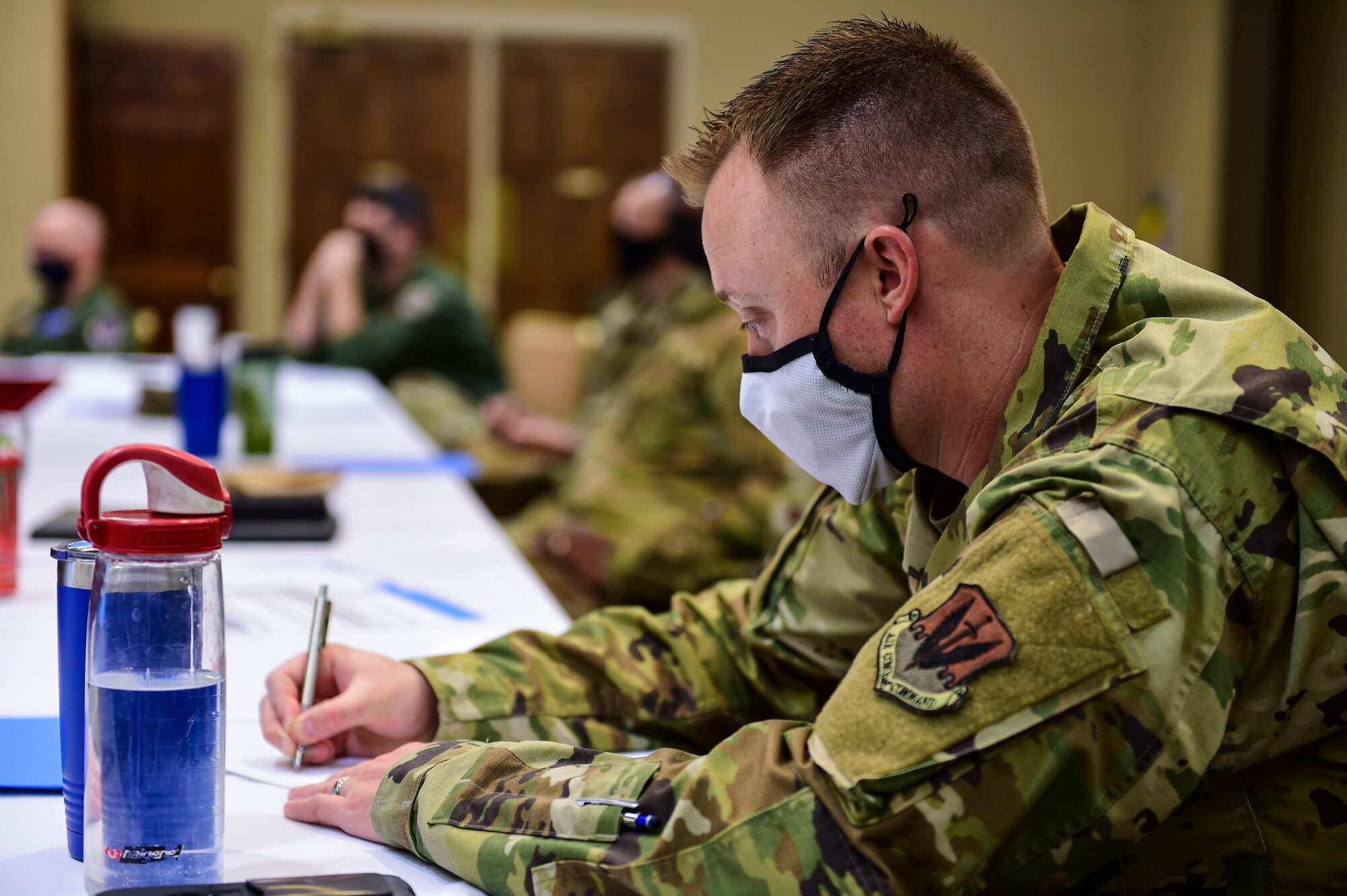 man writing notes