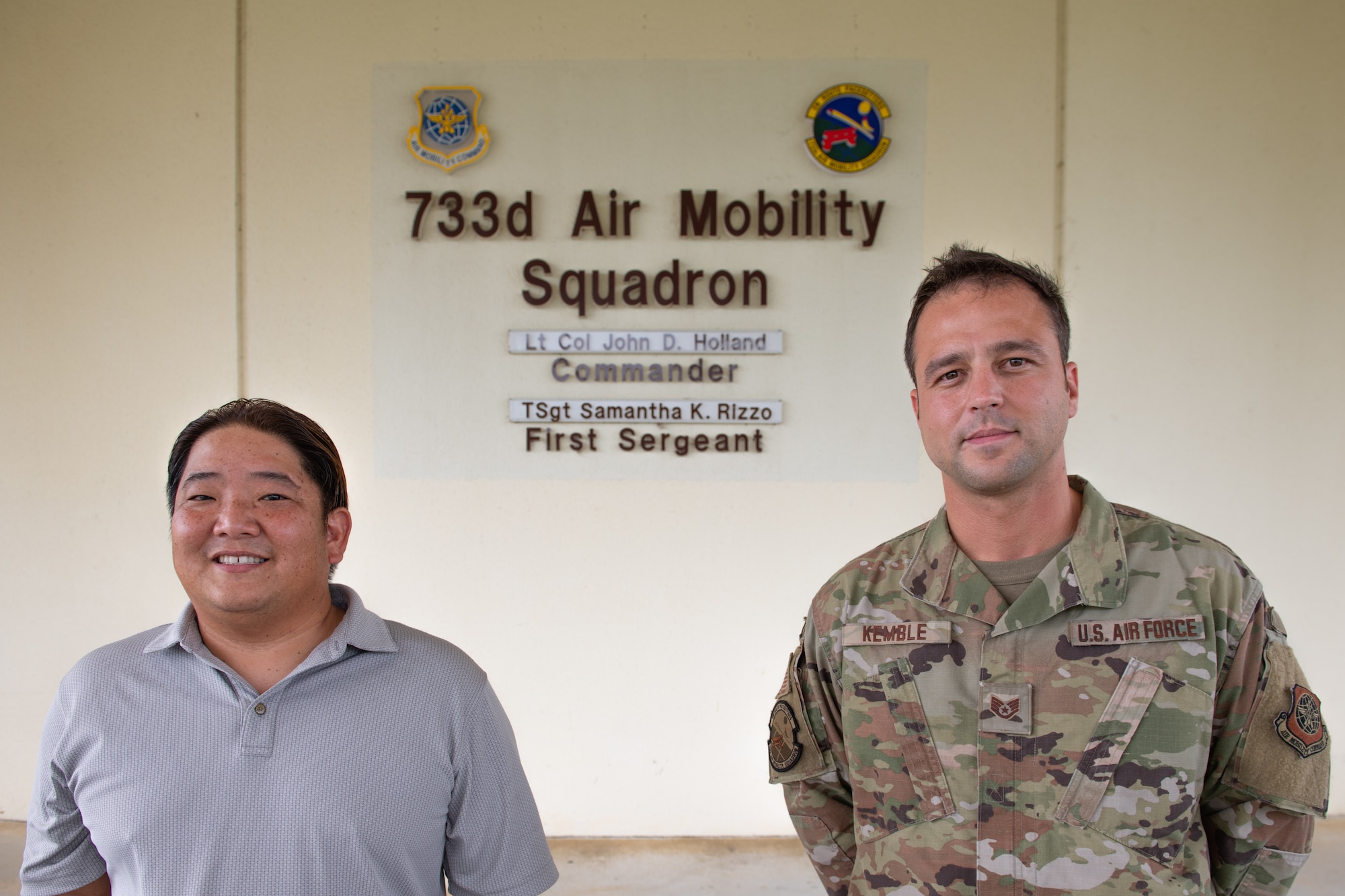 U.S. Air Force GS-11 employee Brandon Yoneda, air terminal operations duty officer, and U.S. Air Force Staff Sgt. Kyle Kemble, asset evaluator, both with the 733rd Air Mobility Squadron, pose for a photo at Kadena Air Base, Japan, Aug. 5, 2021.