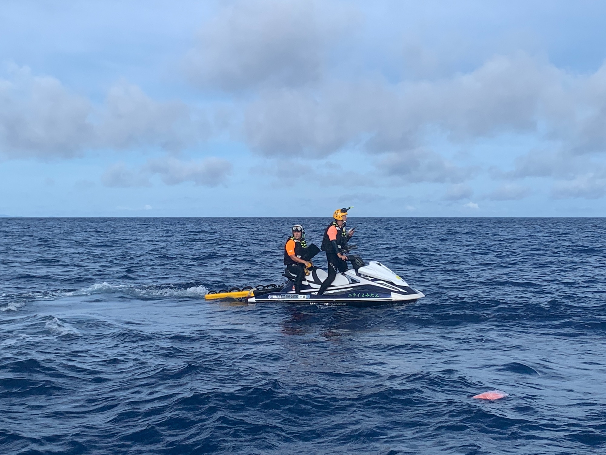 Two Japanese search and rescue members ride a jet ski half a mile off the coast of Cape Zanpa, Okinawa, June 13, 2021.
