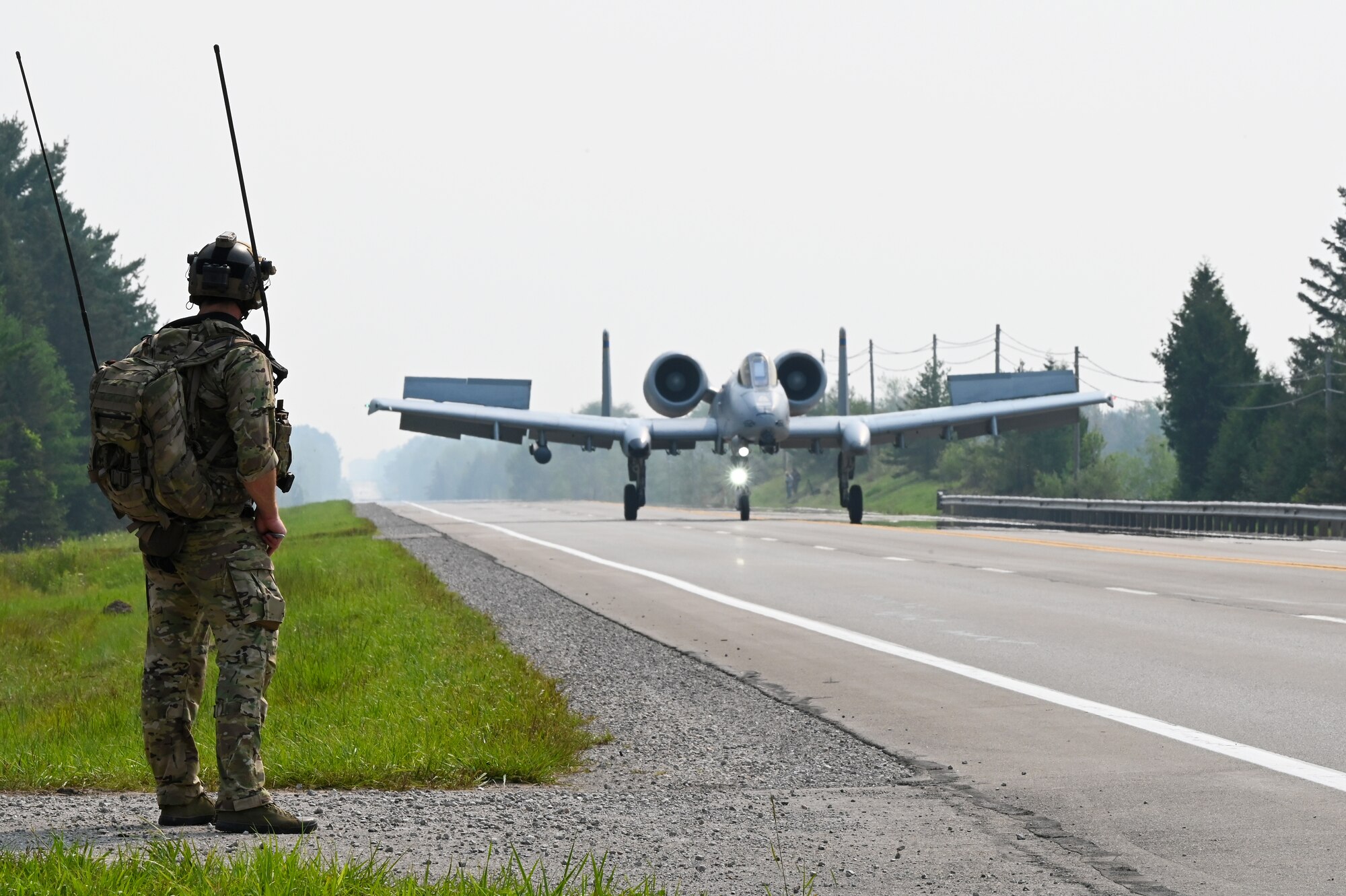 A U.S. Air Force 127th Wing A-10 Thunderbolt II, with ground air traffic control and guidance provided by Special Tactics operators from the 24th Special Operations Wing, lands on a closed public highway Aug. 5, 2021 at Alpena, Mich., for the first time ever as part of a training exercise during Northern Strike 21. The joint training event tested part of the agile employment concept, focusing on projecting combat power from austere locations. (U.S. Air Force photo by Staff Sgt. Ridge Shan)
