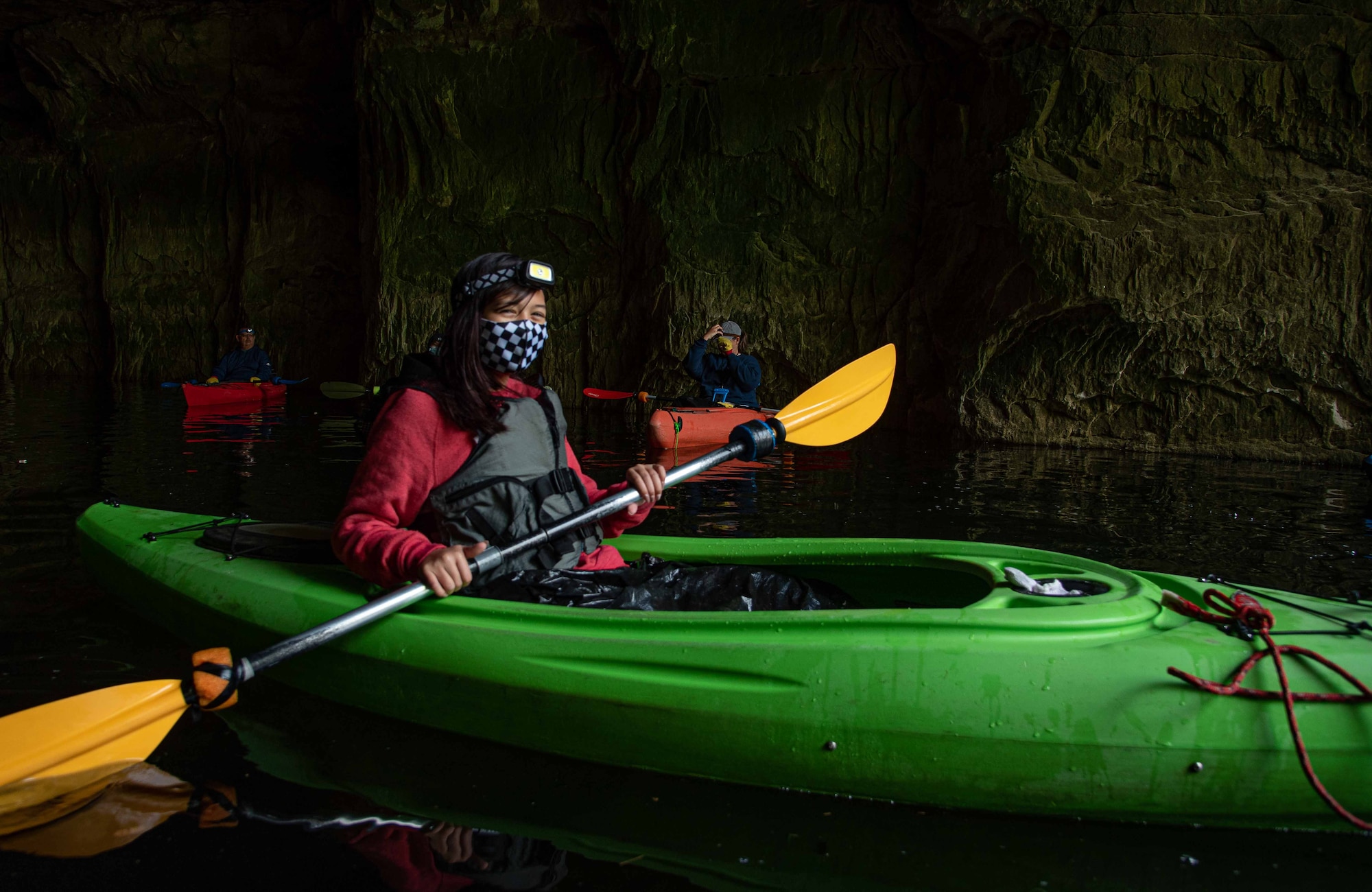 Girl on kayak paddles