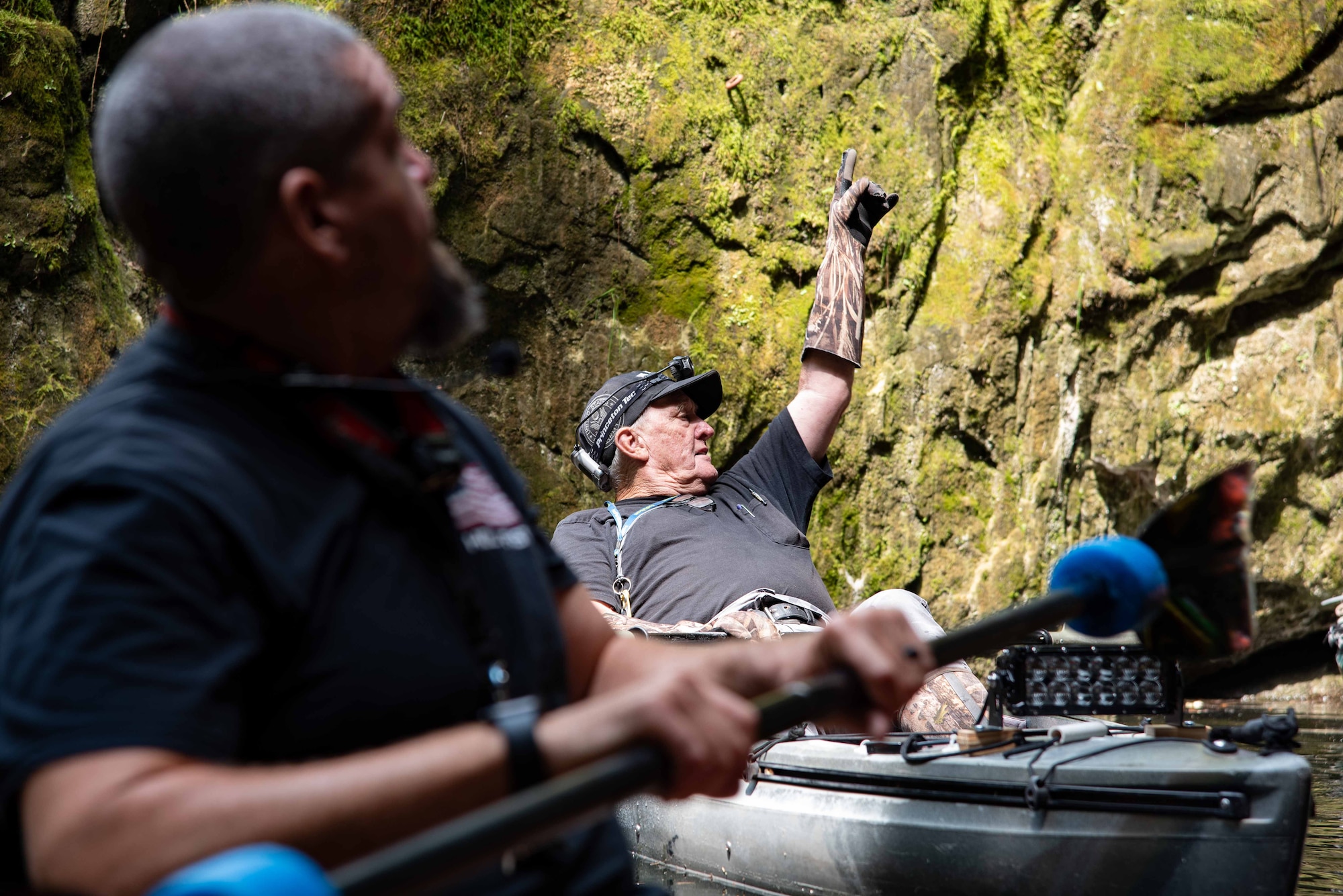 Man on Kayak points upward