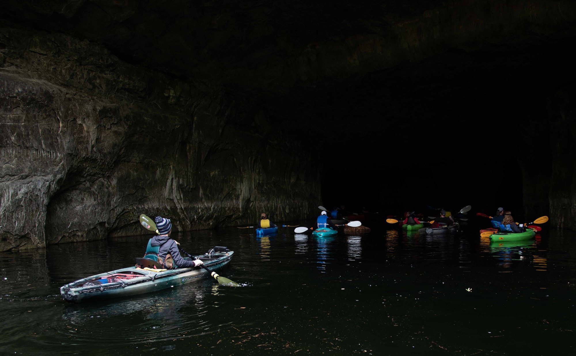 Kayakers at the mouth of a cave