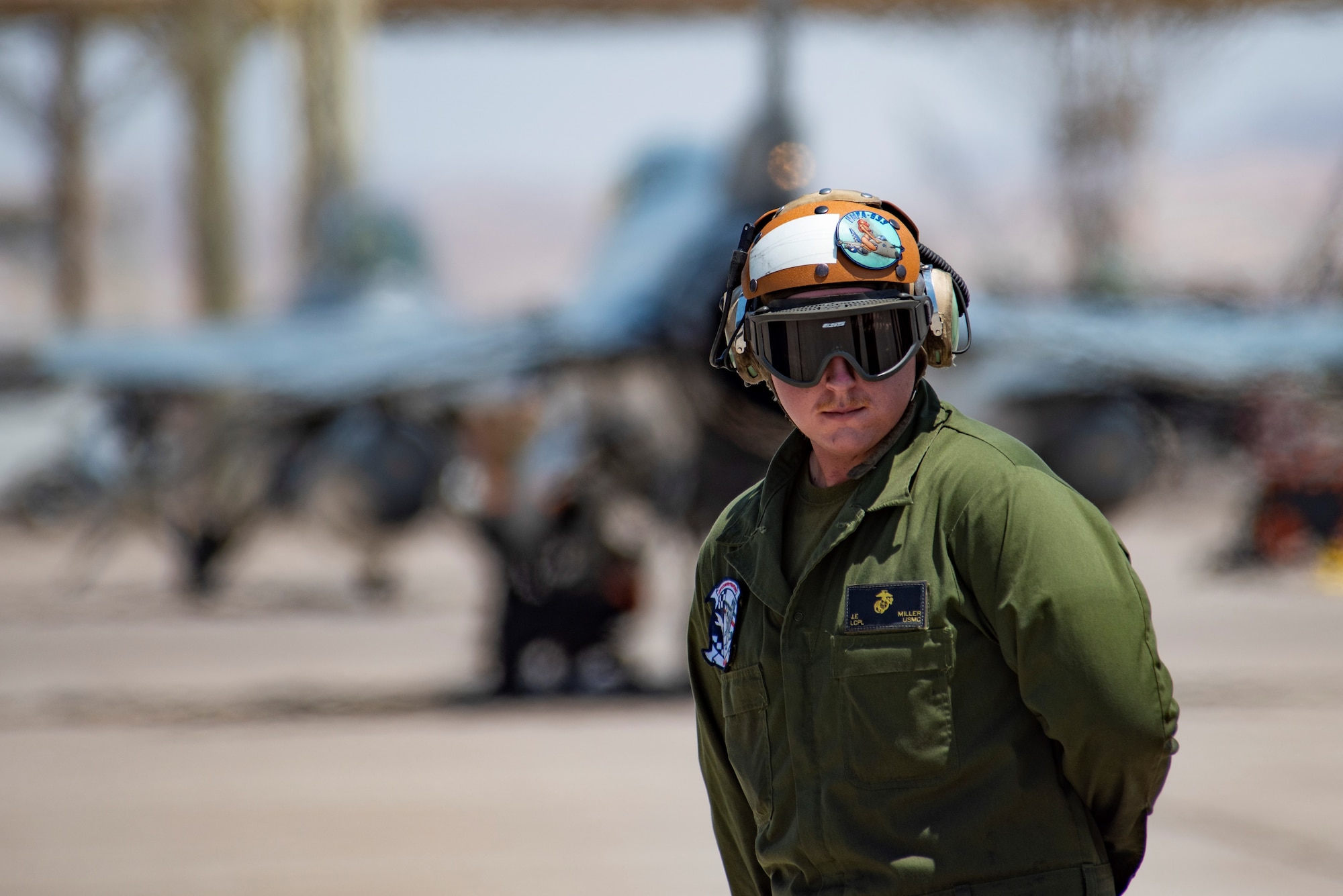 A U.S. Marine Corps maintainer prepares to marshal out an aircraft.