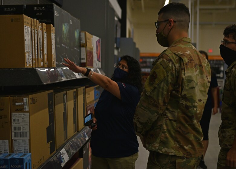 Silvana Marin, Goodfellow Air Force Base Exchange hardlines manager, assists customers with computers during the grand opening of the Exchange on Goodfellow AFB, Texas, Aug. 5, 2021. The Goodfellow Exchange serves more than 4,800 Goodfellow members and over 4,700 retirees and dependents. (U.S. Air Force photo by Senior Airman Ashley Thrash)
