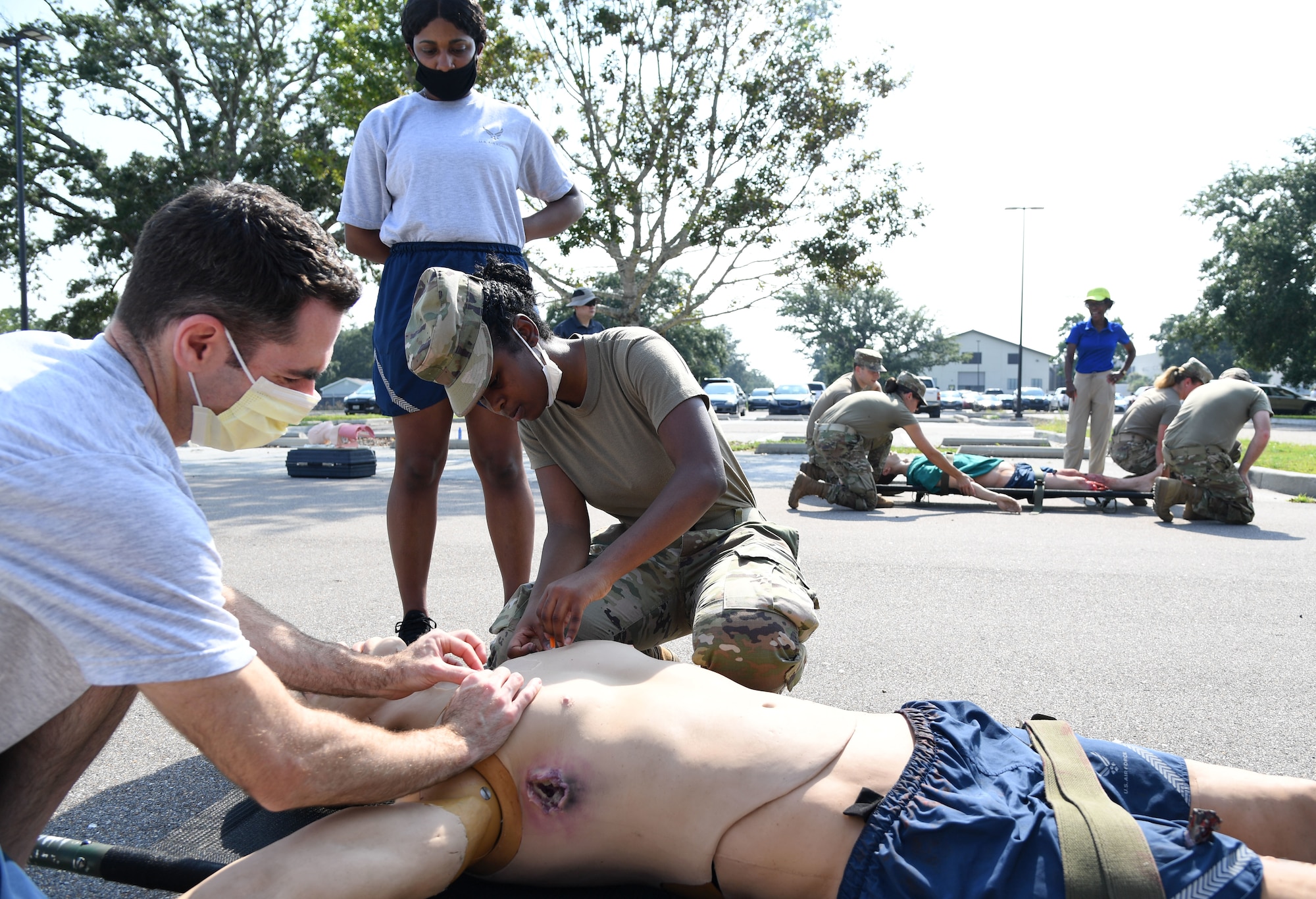 U.S. Air Force Lt. Col. James Renda, 81st Dental Squadron dentist, and Airman 1st Class Heaven Wilborn, 81st Medical Support Squadron medical administrator, provides medical triage to a "patient" while Staff Sgt. Sydney Davis, 81st MDSS unit deployment manager, observes during a Tactical Combat Casualty Care Rodeo at Keesler Air Force Base, Mississippi, August 5, 2021. The rodeo, a Ready Eagle Training component, provides practical hands-on critical medical trauma skills training for 81st Medical Group personnel. (U.S. Air Force photo by Kemberly Groue)