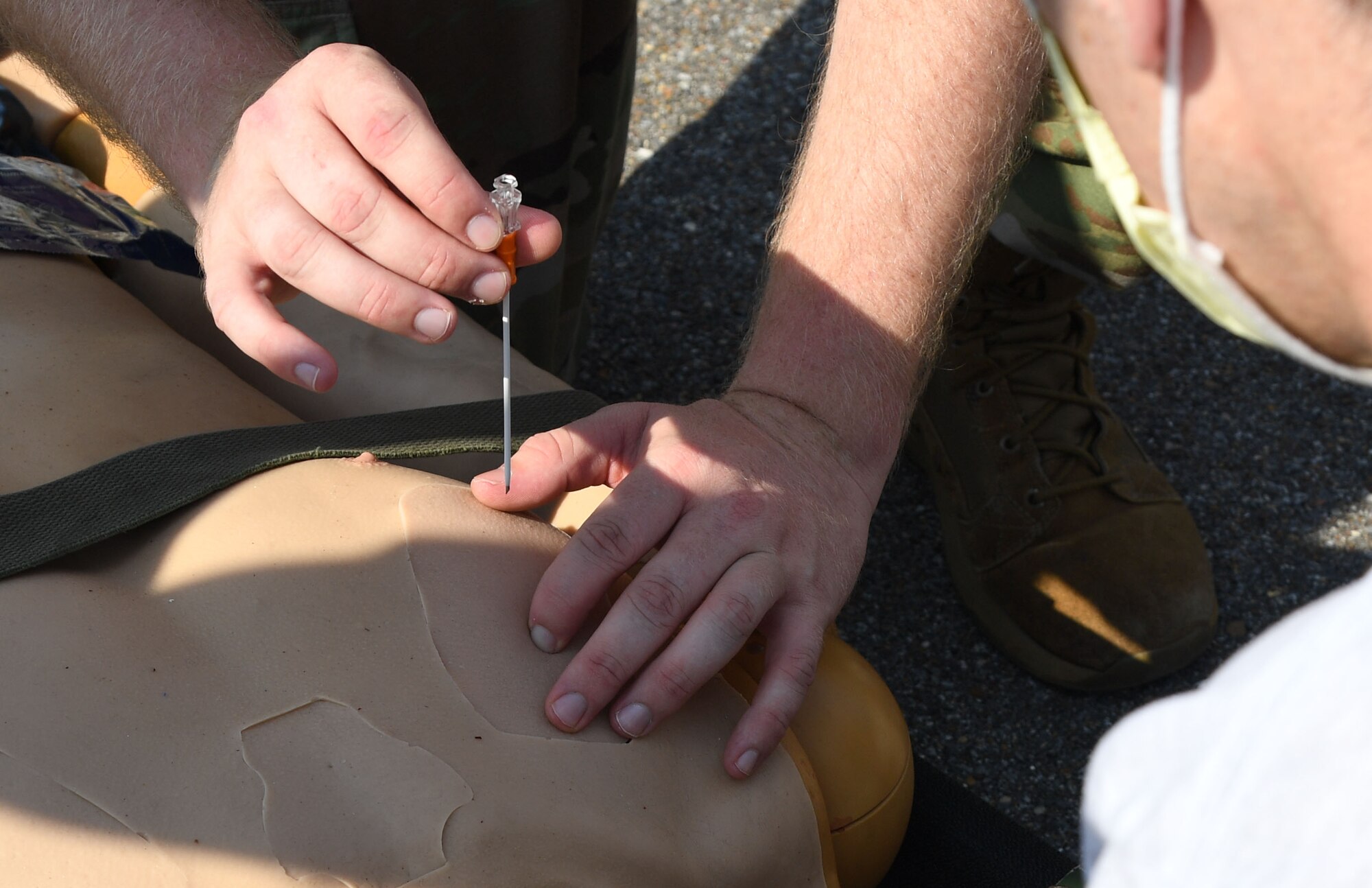 U.S. Air Force Staff Sgt. Timothy Parde, 81st Medical Support Squadron emergency medical services site coordinator, provides a triage procedure demonstration during a Tactical Combat Casualty Care Rodeo at Keesler Air Force Base, Mississippi, August 5, 2021. The rodeo, a Ready Eagle Training component, provides practical hands-on critical medical trauma skills training for 81st Medical Group personnel. (U.S. Air Force photo by Kemberly Groue)