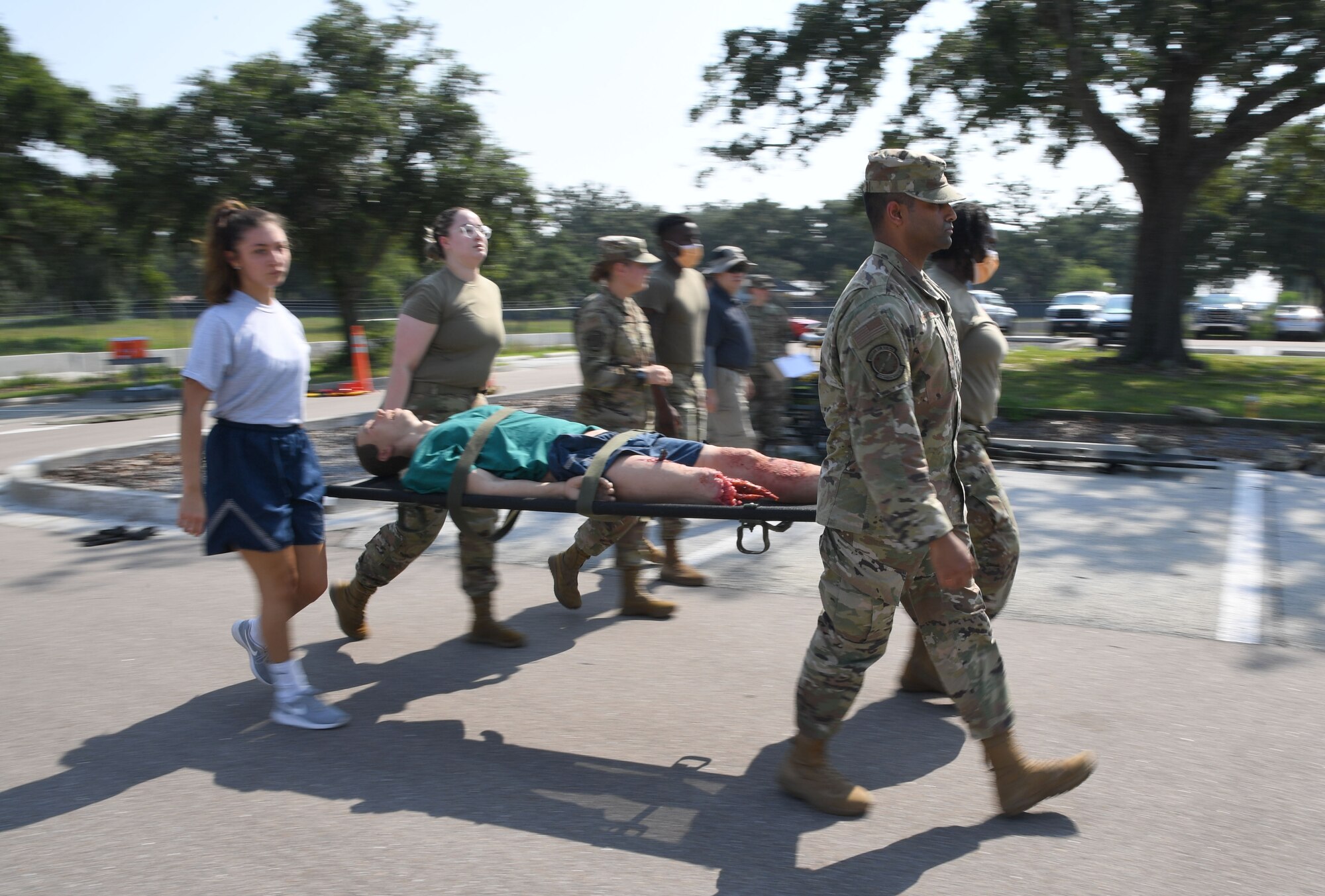 Members from the 81st Medical Group participate in a litter carry during a Tactical Combat Casualty Care Rodeo at Keesler Air Force Base, Mississippi, August 5, 2021. The rodeo, a Ready Eagle Training component, provides practical hands-on critical medical trauma skills training for 81st MDG personnel. (U.S. Air Force photo by Kemberly Groue)